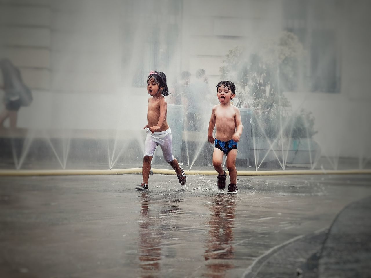 FULL LENGTH OF SHIRTLESS BOY WITH WATER