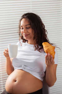 Young woman holding ice cream