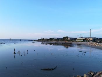 Scenic view of lake against clear blue sky