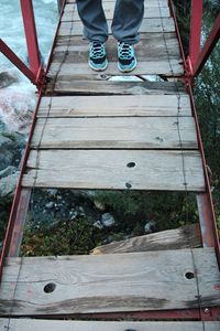 Low section of woman walking on bridge