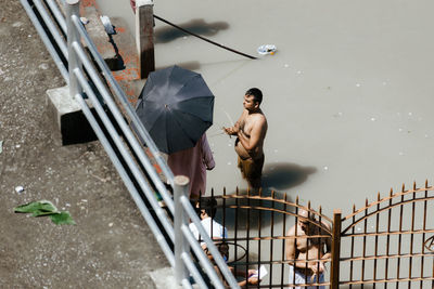 High angle view of man standing on railing