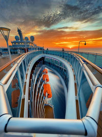 Bridge over sea against sky during sunset