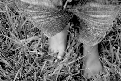 Low section of woman standing on field