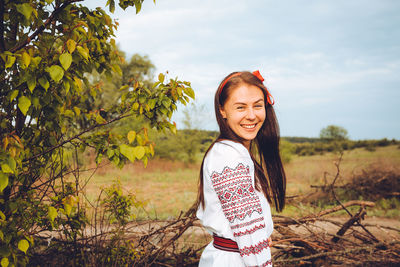 Photo of a smiling young woman in ethnic ukrainian shirt