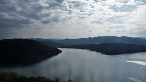 Scenic view of lake and mountains against sky