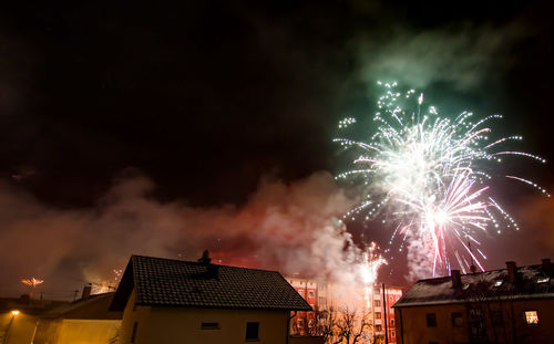 Low angle view of firework display at night