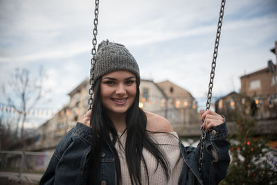 Young woman sitting on swing