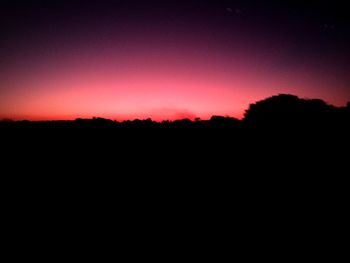 Scenic view of silhouette mountains against sky during sunset