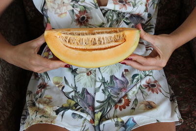 Midsection of woman holding ice cream