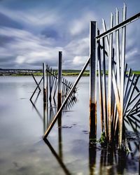 Long exposure if fences post in sea at tipner in portsmouth . . .