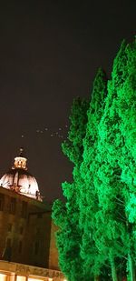 Illuminated building against sky at night