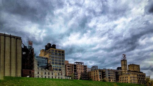 Buildings against cloudy sky