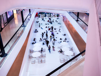 High angle view of people on escalator in shopping mall