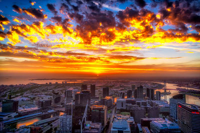 High angle view of buildings against cloudy sky during sunset