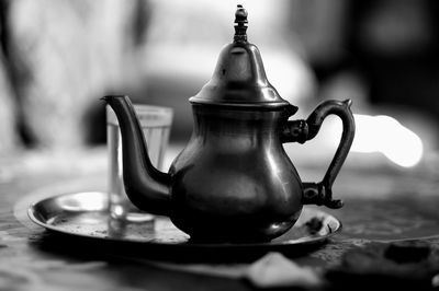 Close-up of teapot and glass on tray