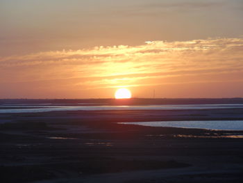 Scenic view of sea against romantic sky at sunset