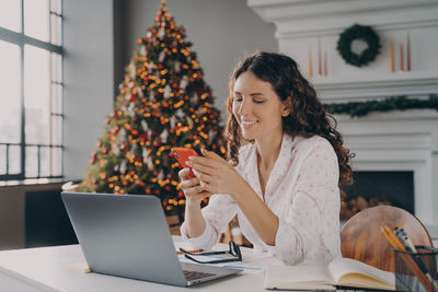 Young woman using laptop on table