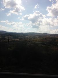 Scenic view of mountains against cloudy sky