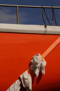 Close-up of person holding umbrella hanging against white wall