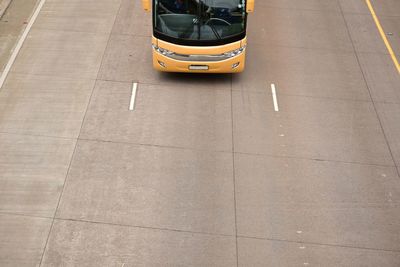 High angle view of yellow bus on road