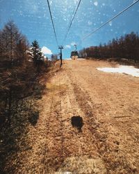 Overhead cable car against sky