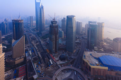 High angle view of modern buildings in city against sky