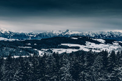 Scenic view of mountains against sky during winter