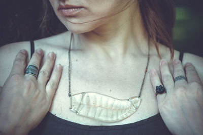 Close up woman with handmade floral pendant concept photo