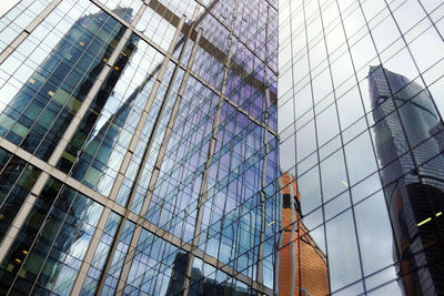 Low angle view of modern glass building in city