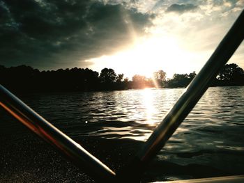 Scenic view of river against cloudy sky