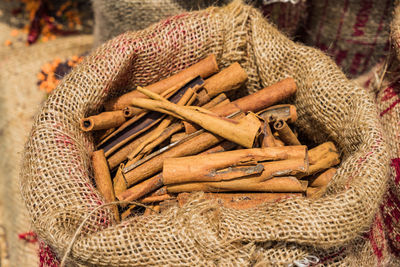 High angle view of cinnamon on in sack market