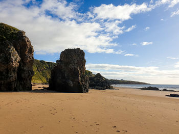 Rocks on beach against sky