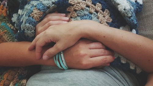 Midsection of couple holding hands