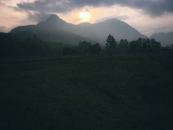 Scenic view of silhouette mountains against sky during sunset