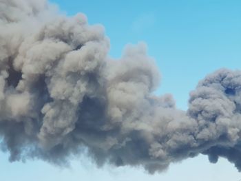 Low angle view of smoke against sky