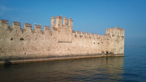 View of fort against blue sky and ocean