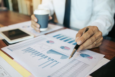 Midsection of businessman working in office