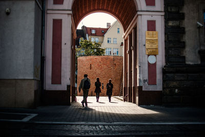 People walking below gate