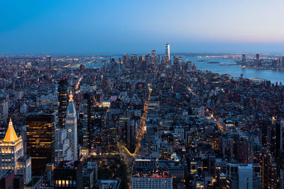 High angle view of illuminated cityscape against sky