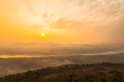 Scenic view of landscape against sky during sunset