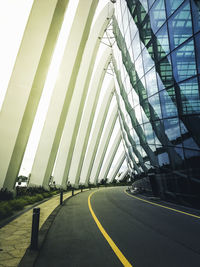 Empty road by modern building in city