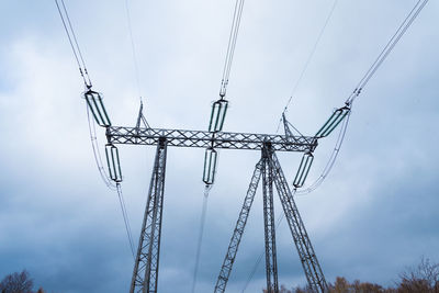 Low angle view of electricity pylon against sky