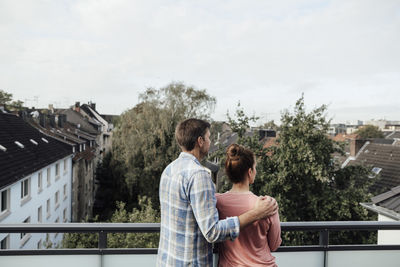 Mature couple standing spending leisure time together in balcony