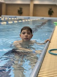 Portrait of boy swimming in pool