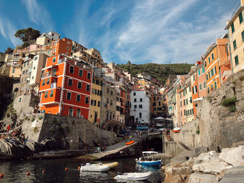 Panoramic view of buildings by sea against sky