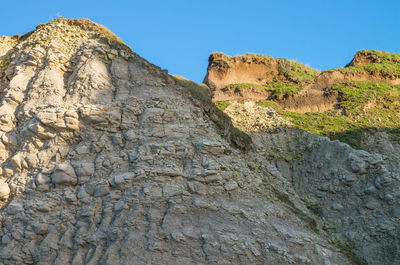 Low angle view of rock formation against clear sky