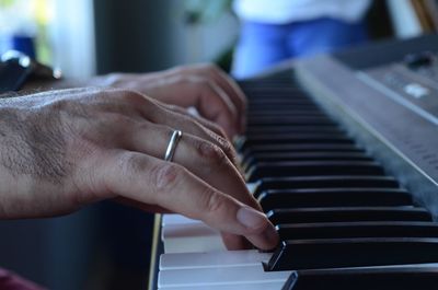 Midsection of man playing piano