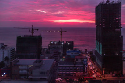 High angle view of illuminated buildings against sky during sunset