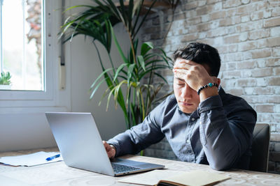 Young woman using laptop at office