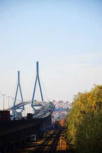 Bridge over river in city against sky